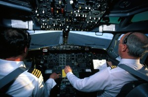 Pilots in the cockpit of an aircraft.